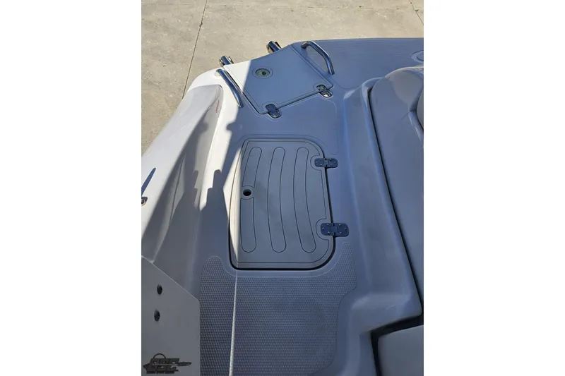 Slide: The Image of 2015 Tahoe 215 Xi boat deck with storage compartment and sleek design. - 110