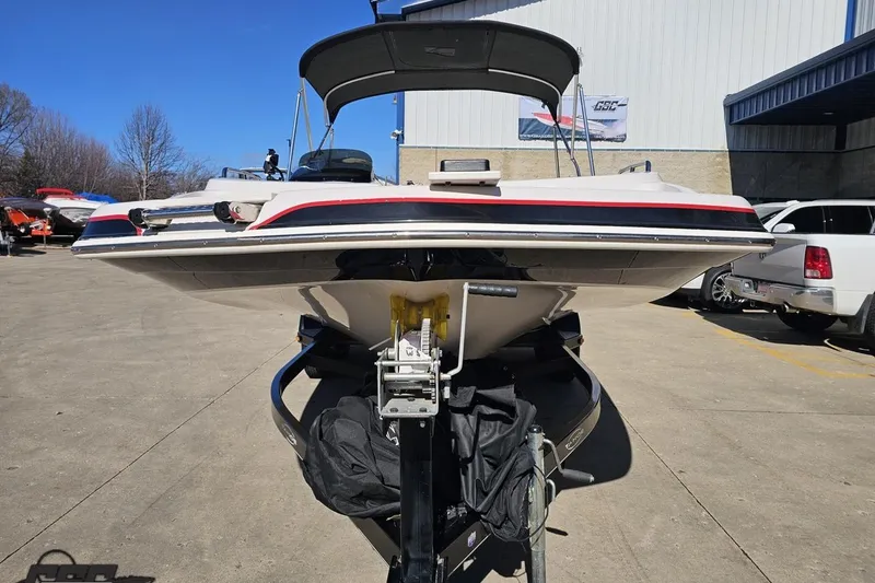 Slide: The Image of 2015 Tahoe 215 Xi boat on trailer in outdoor parking lot. - 21