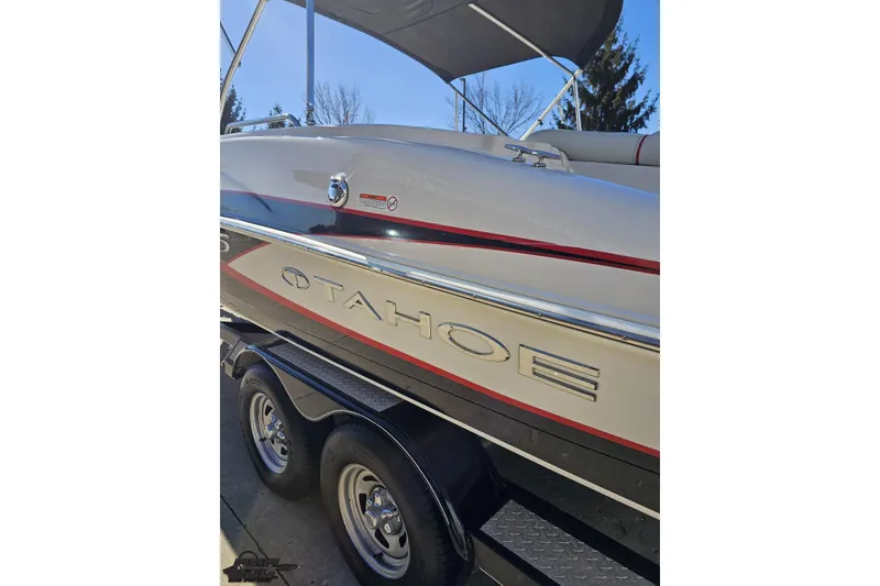 Slide: The Image of 2015 Tahoe 215 Xi boat on trailer, featuring sleek design and chrome accents. - 31