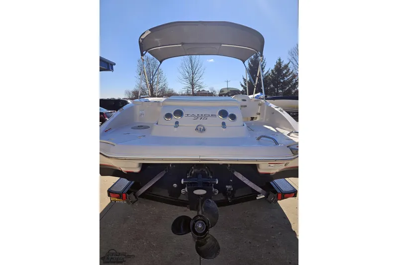 Slide: The Image of 2015 Tahoe 215 Xi boat rear view with canopy and outboard motor. - 37