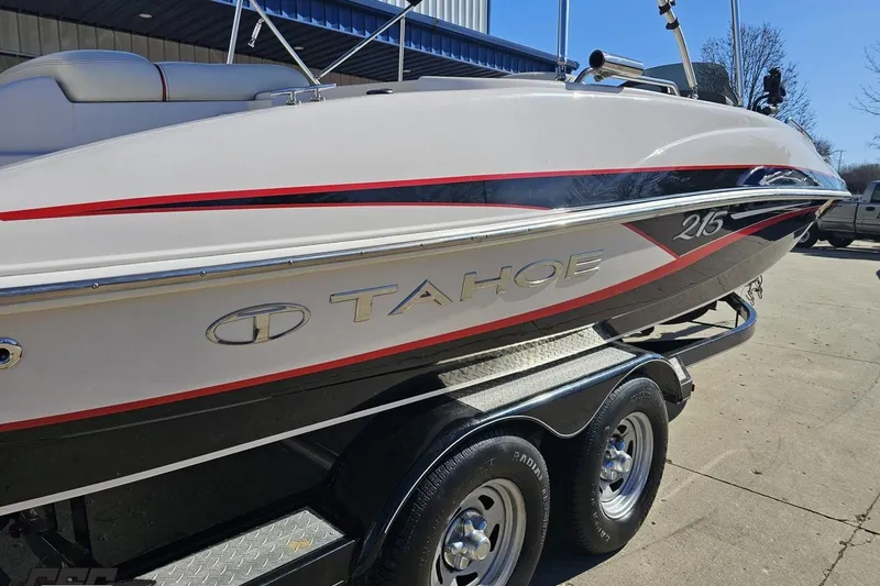 Slide: The Image of 2015 Tahoe 215 Xi boat on trailer, featuring sleek design and red accents. - 41