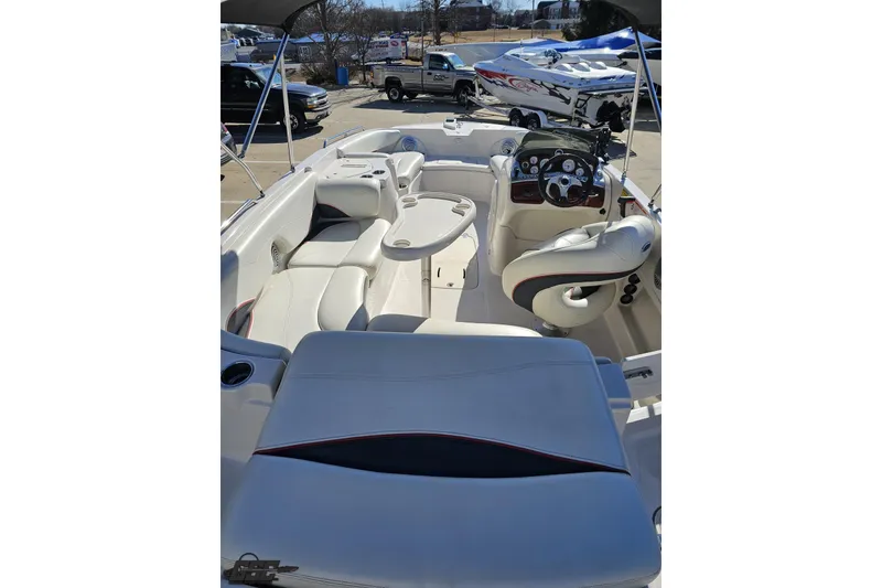 Slide: The Image of 2015 Tahoe 215 Xi boat interior with white seating and steering console. - 45