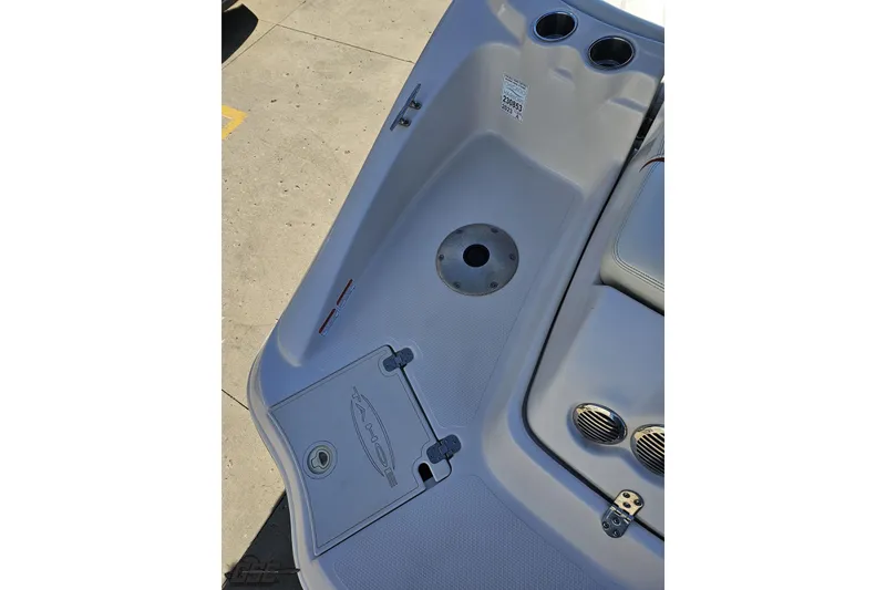 Slide: The Image of 2015 Tahoe 215 Xi boat interior with cup holders and storage compartment. - 47