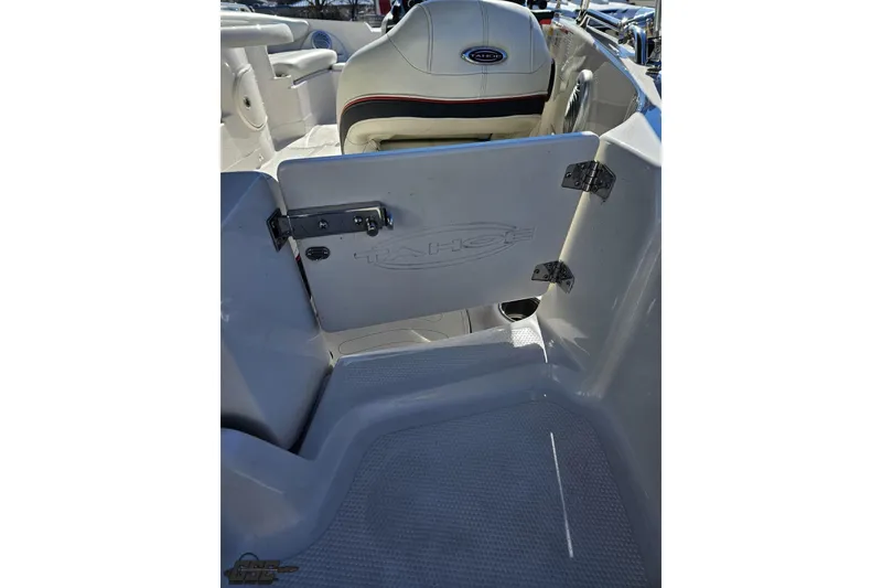 Slide: The Image of 2015 Tahoe 215 Xi boat interior with open storage compartment and seating. - 49