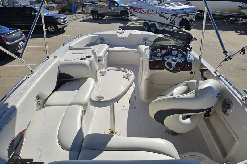 Slide: The Image of 2015 Tahoe 215 Xi boat interior with white seating and steering console. - 51