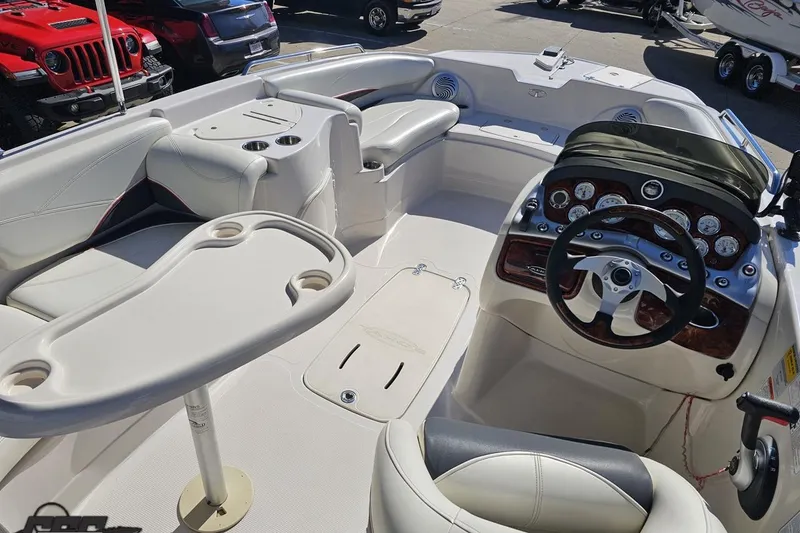 Slide: The Image of Interior of a 2015 Tahoe 215 Xi boat featuring steering wheel and seating area. - 52