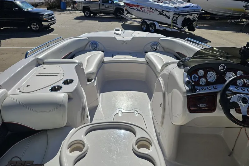 Slide: The Image of Interior view of a 2015 Tahoe 215 Xi boat, featuring sleek seating and control panel. - 60