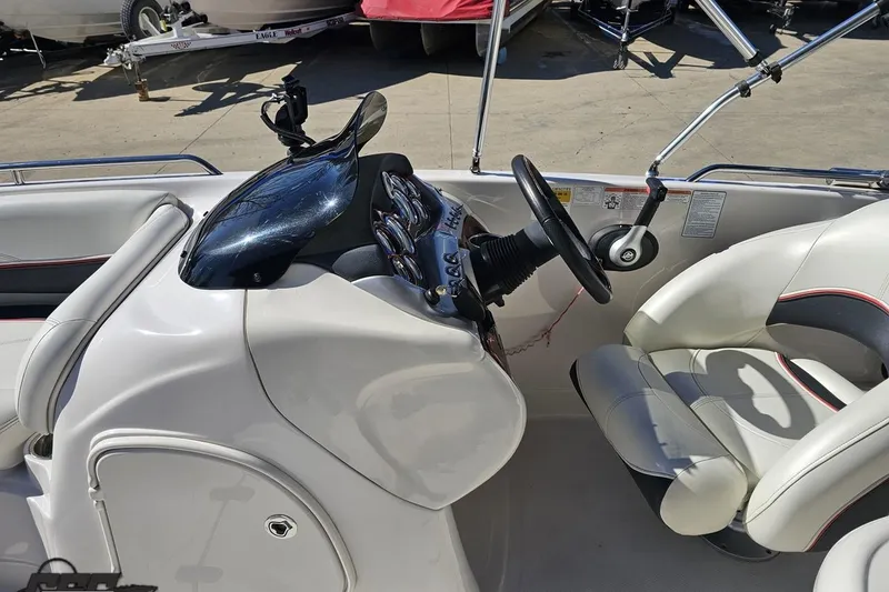 Slide: The Image of 2015 Tahoe 215 Xi boat interior with steering wheel and seating. - 61