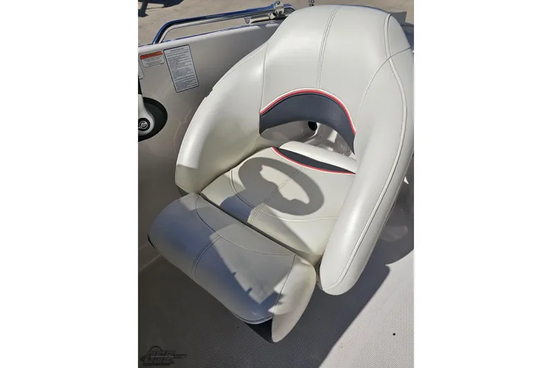 Slide: The Image of 2015 Tahoe 215 Xi boat seat with white and gray upholstery, featuring red accents. - 63