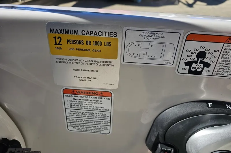 Slide: The Image of 2015 Tahoe 215 Xi boat capacity label, warning signs, and seating diagram. - 66