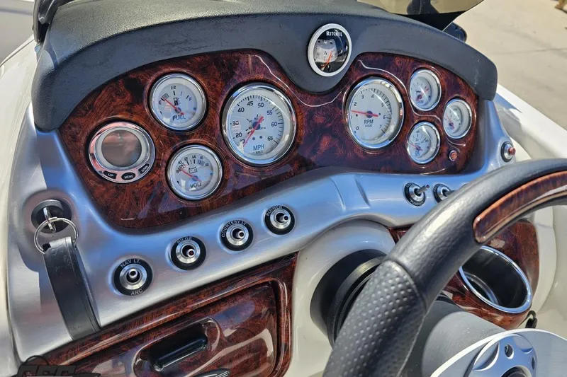 Slide: The Image of Dashboard of a 2015 Tahoe 215 Xi boat with gauges and controls. - 67