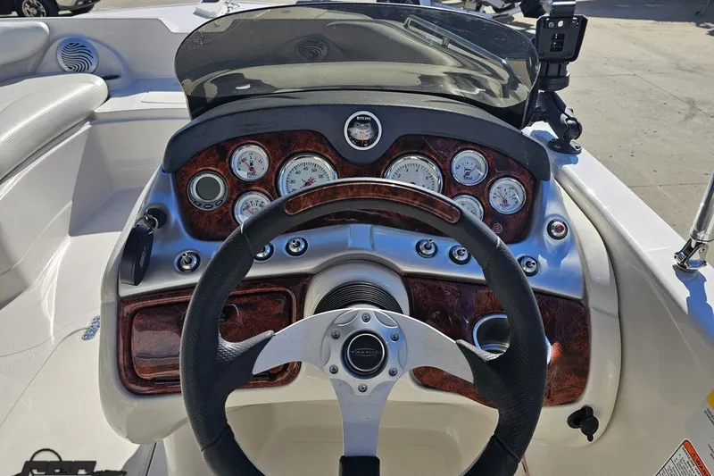 Slide: The Image of Cockpit view of a 2015 Tahoe 215 Xi boat with detailed dashboard controls. - 68