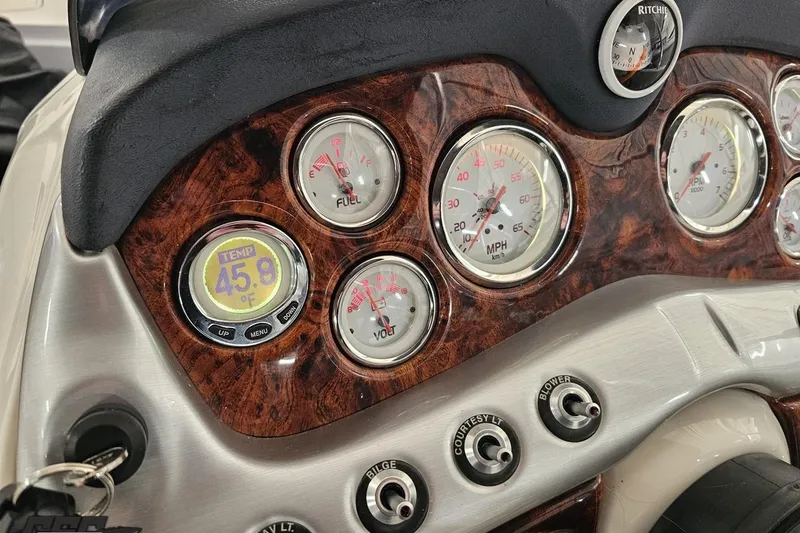 Slide: The Image of Dashboard of a 2015 Tahoe 215 Xi boat with gauges and temperature display. - 71