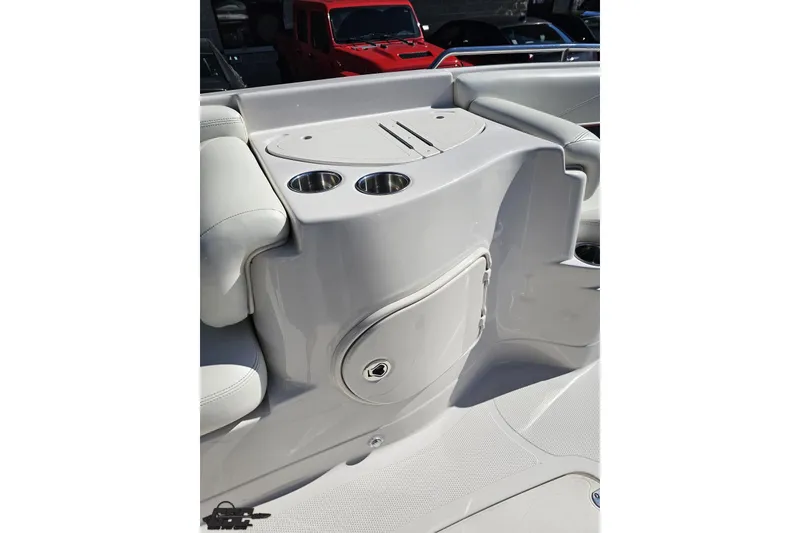 Slide: The Image of 2015 Tahoe 215 Xi boat interior with cup holders and storage compartment. - 75