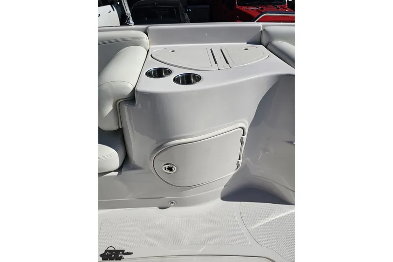 Slide: The Image of 2015 Tahoe 215 Xi boat interior with cup holders and storage compartment. - 76