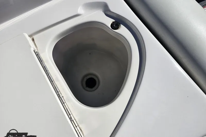 Slide: The Image of 2015 Tahoe 215 Xi boat sink with drain, white surface, and hinge detail. - 78