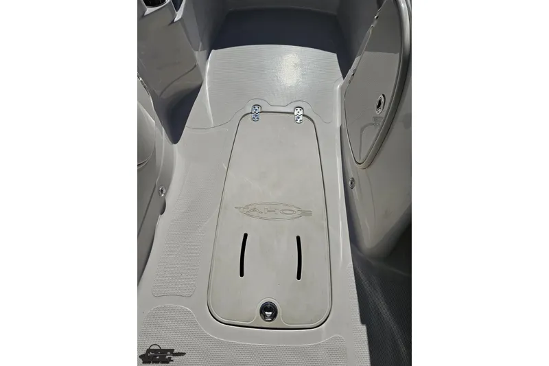Slide: The Image of 2015 Tahoe 215 Xi boat interior with storage compartment and textured flooring. - 80