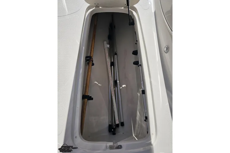 Slide: The Image of Storage compartment of a 2015 Tahoe 215 Xi boat, featuring organized equipment. - 81