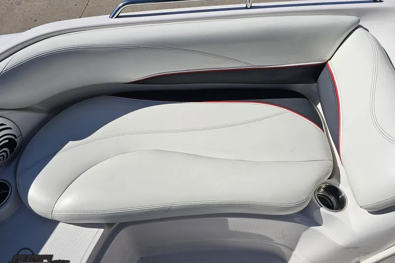 Slide: The Image of 2015 Tahoe 215 Xi boat interior with white cushioned seating and cup holders. - 86