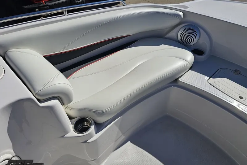 Slide: The Image of 2015 Tahoe 215 Xi boat interior with white cushioned seating and built-in speaker. - 89