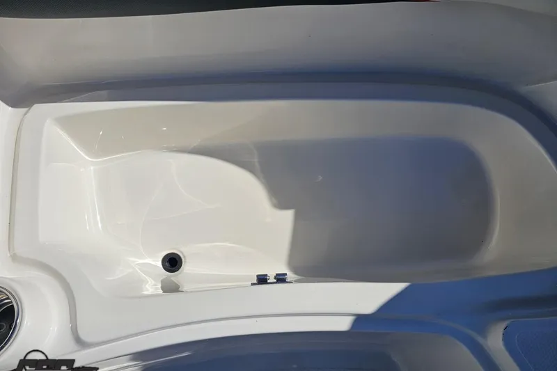 Slide: The Image of 2015 Tahoe 215 Xi boat interior detail, featuring a clean white compartment. - 92