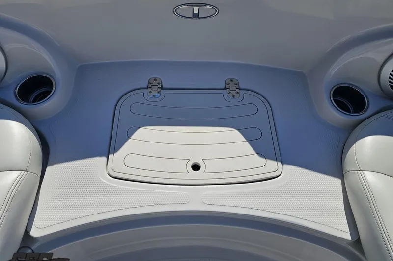 Slide: The Image of Interior of a 2015 Tahoe 215 Xi boat, featuring cup holders and storage compartment. - 95