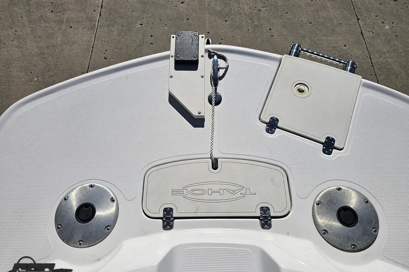 Slide: The Image of 2015 Tahoe 215 Xi boat deck with storage compartments and rope cleat. - 97