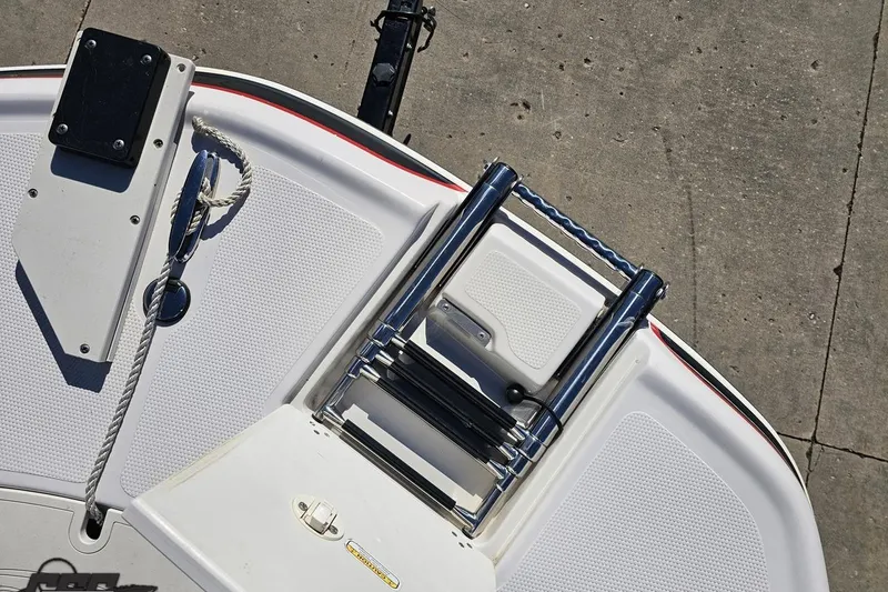 Slide: The Image of 2015 Tahoe 215 Xi boat swim platform with ladder and cleat on concrete dock. - 99