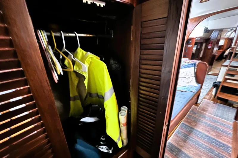 Slide: The Image of 1985 Gulfstar Hirsch Center Cockpit interior with kitchen sink, stove, and cozy seating area. - 12