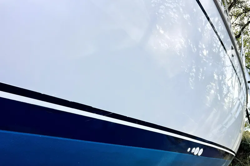 Slide: The Image of 1985 Gulfstar Hirsch Center Cockpit bathroom with sink, mirror, and wooden accents. - 20