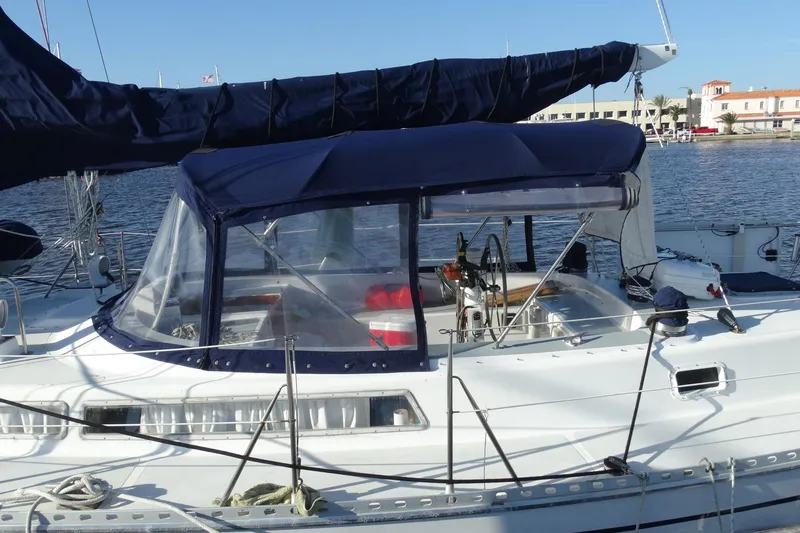 Slide: The Image of 1985 Gulfstar Hirsch Center Cockpit sailboat docked with solar panel and blue canopy. - 27