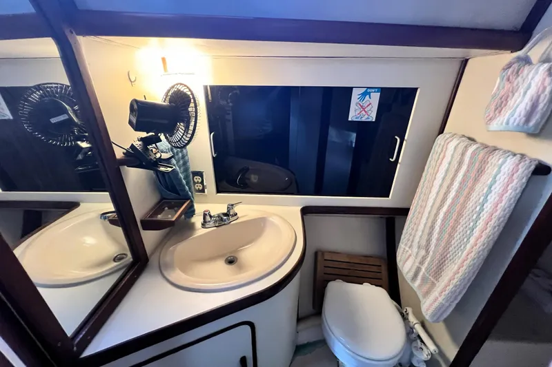 Slide: The Image of 1985 Gulfstar Hirsch Center Cockpit boat with "Jesus Saves" text and ladder. - 5