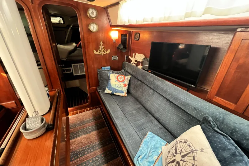 Slide: The Image of Interior of 1985 Gulfstar Hirsch Center Cockpit with nautical decor and framed artwork. - 8
