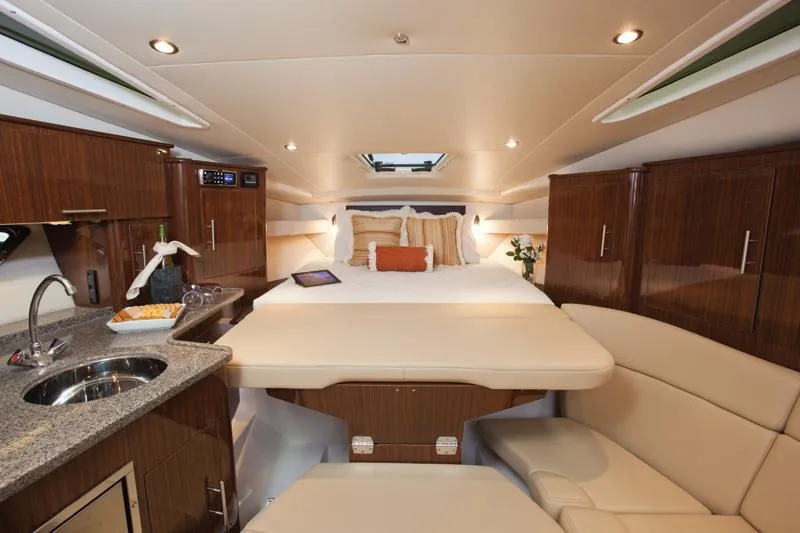 Slide: The Image of Manufacturer Provided Image: Luxurious interior of 2015 Regal 35 Sport Coupe with bed, kitchenette, and seating area. - 8