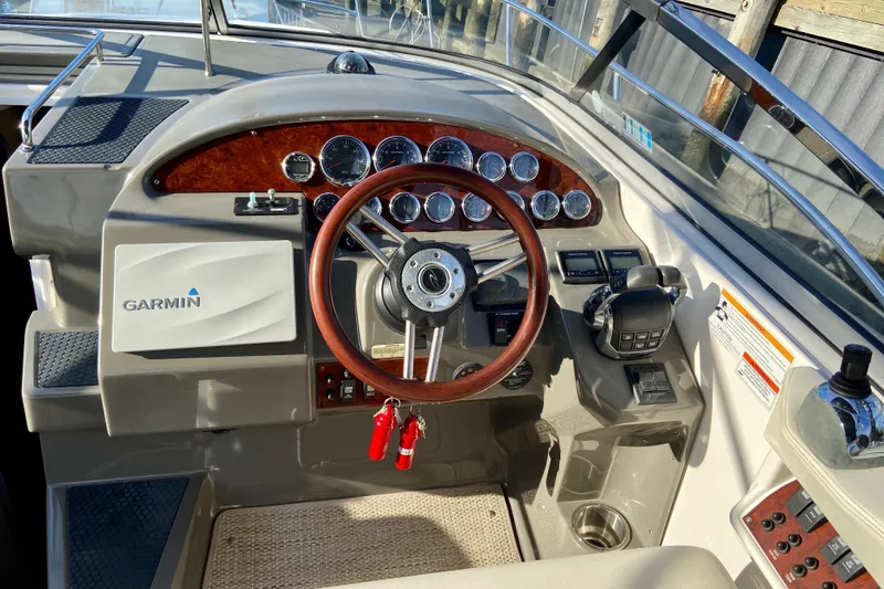 Slide: The Image of 2012 Regal 35 Express Cruiser helm with Garmin navigation and wood-accented steering wheel. - 10