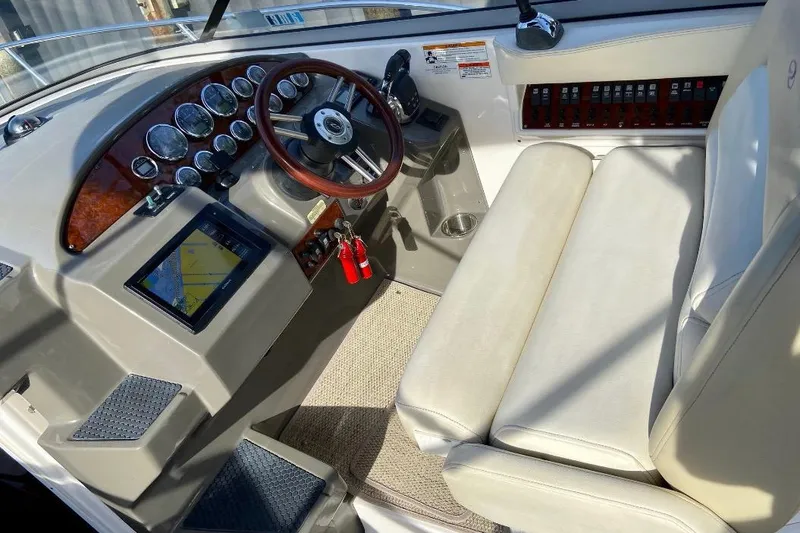 Slide: The Image of Cockpit of 2012 Regal 35 Express Cruiser with steering wheel and navigation display. - 11