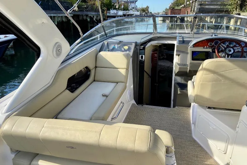 Slide: The Image of Interior of 2012 Regal 35 Express Cruiser with beige seating and modern dashboard. - 12