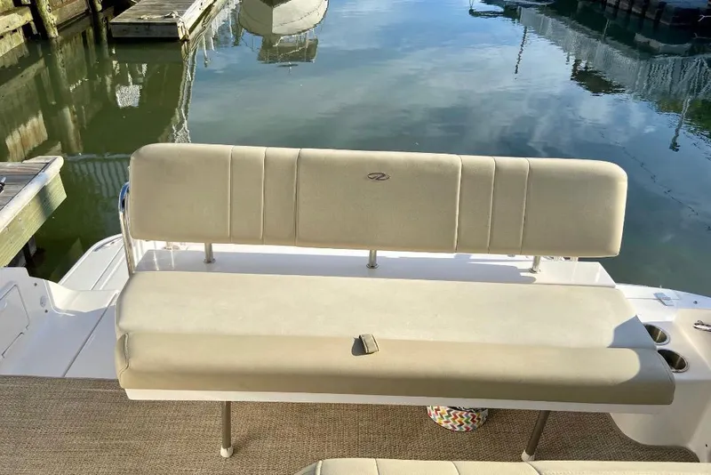 Slide: The Image of 2012 Regal 35 Express Cruiser boat seating by the water. - 14