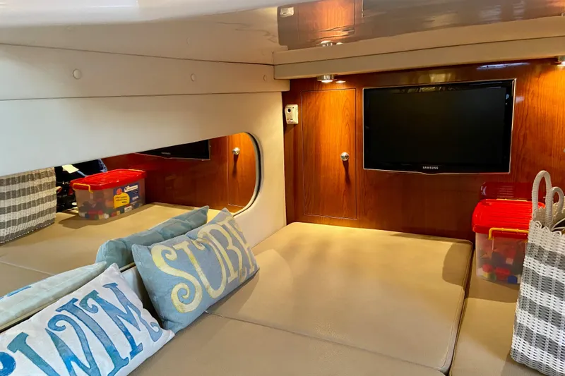 Slide: The Image of Cozy interior of 2012 Regal 35 Express Cruiser with TV and decorative pillows. - 16