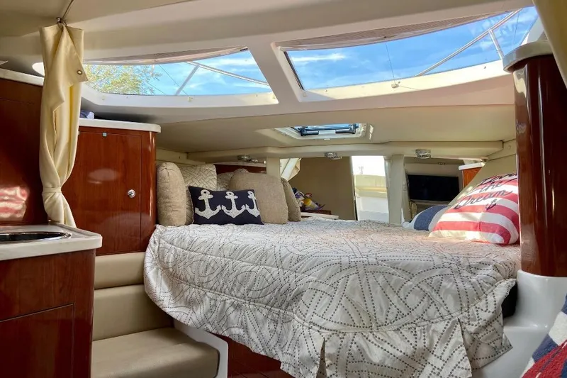 Slide: The Image of Luxurious interior cabin of 2012 Regal 35 Express Cruiser with skylight and nautical decor. - 17