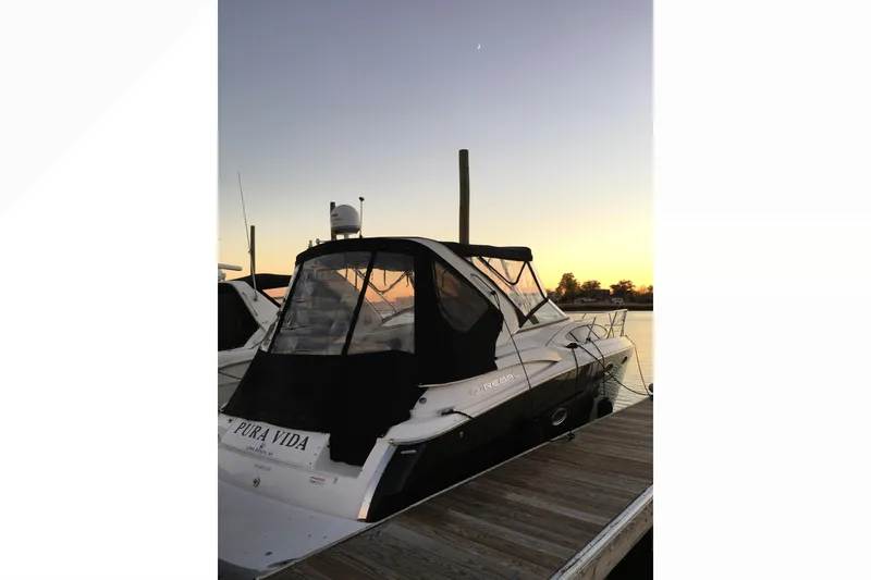 Slide: The Image of 2012 Regal 35 Express Cruiser docked at sunset, rear view. - 4