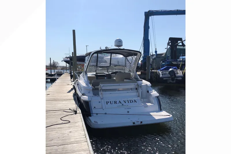 Slide: The Image of 2012 Regal 35 Express Cruiser docked at marina, rear view. - 6