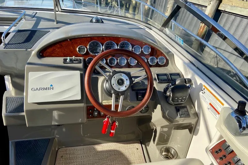Slide: The Image of 2012 Regal 35 Express Cruiser helm with Garmin navigation and wood-accented steering wheel. - 9