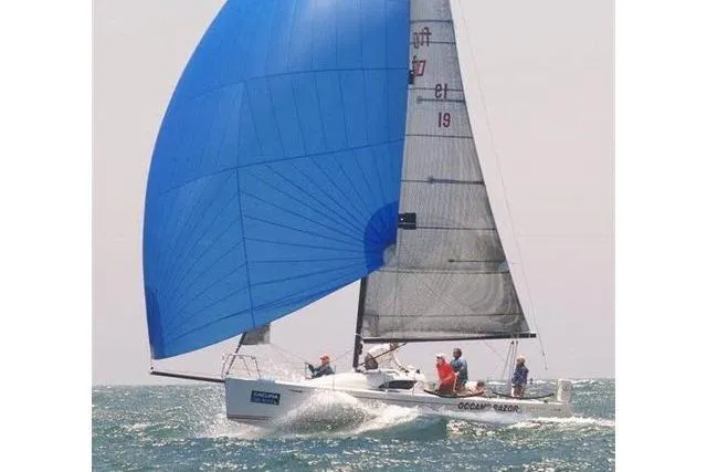 Slide: The Image of Sailing yacht Flying Tiger 10M, 2006 model, with blue spinnaker on open water. - 16