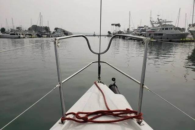 Slide: The Image of Bow view of a 2006 Flying Tiger 10M sailboat in a marina with moored yachts. - 5