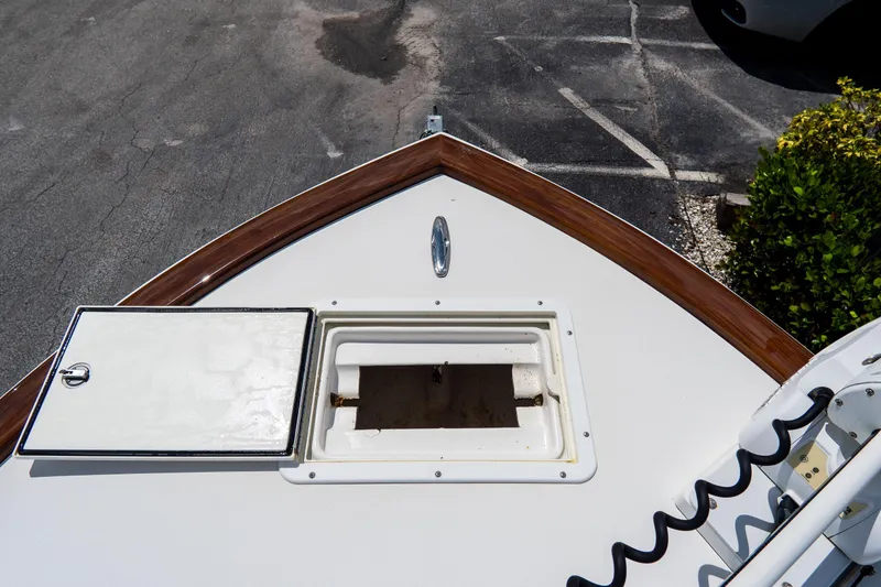 Slide: The Image of Bow of 2022 Croswait 21 boat with open hatch, parked on asphalt. - 14