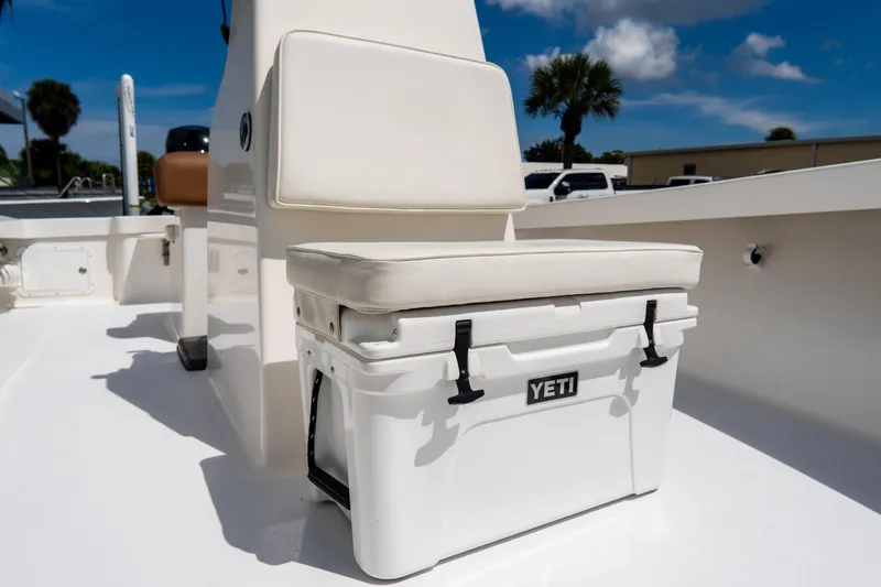 Slide: The Image of White YETI cooler on 2022 Croswait 21 boat deck under sunny sky. - 18
