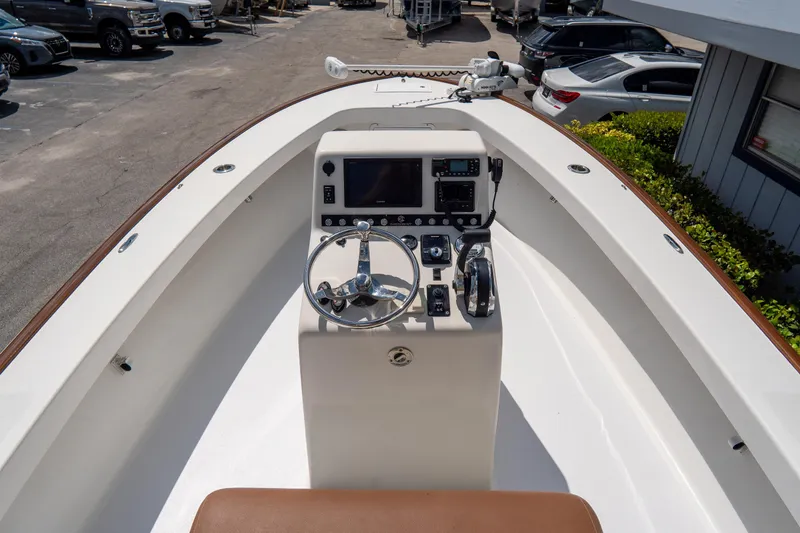 Slide: The Image of Croswait 21 boat dashboard with steering wheel and controls, 2022 model. - 19