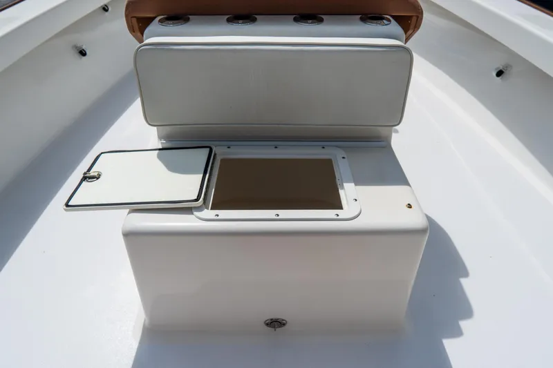 Slide: The Image of 2022 Croswait 21 boat interior with open storage compartment on deck. - 28