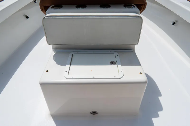 Slide: The Image of Croswait 21 boat interior, 2022 model, featuring a white storage compartment and cushioned seat. - 29